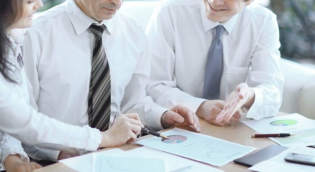 business people working together analyzing financial figures graphs business 160672 405 1