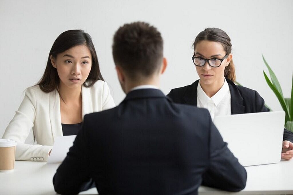 serious unconvinced diverse hr managers interviewing male job applicant 1163 4675 1