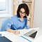 pretty brunette girl blue shirt is working table office she is writing notebook seriously 1
